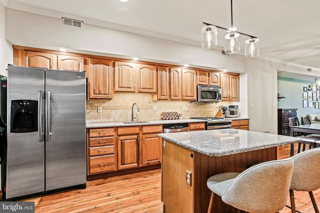 268 S E Ave, Baltimore, MD 21224 - kitchen with appliances with stainless steel finishes, ornamental molding, light wood-style floors, light stone countertops, and tasteful backsplash