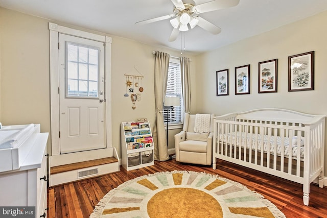 268 S E Ave, Baltimore, MD 21224 - bedroom with hardwood / wood-style floors, a crib, and a ceiling fan
