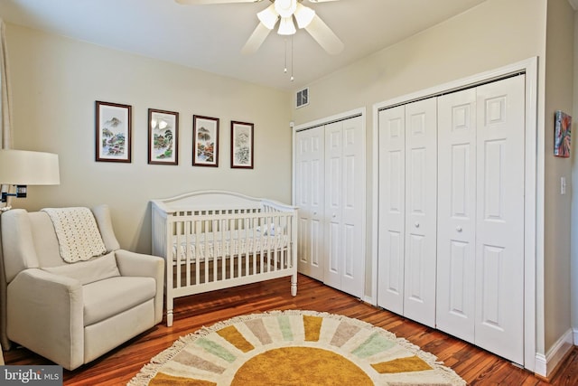 268 S E Ave, Baltimore, MD 21224 - bedroom with wood finished floors, multiple closets, a nursery area, and ceiling fan