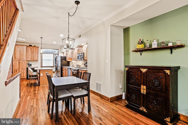 268 S E Ave, Baltimore, MD 21224 - dining room with light wood-style flooring, ornamental molding, recessed lighting, and a chandelier