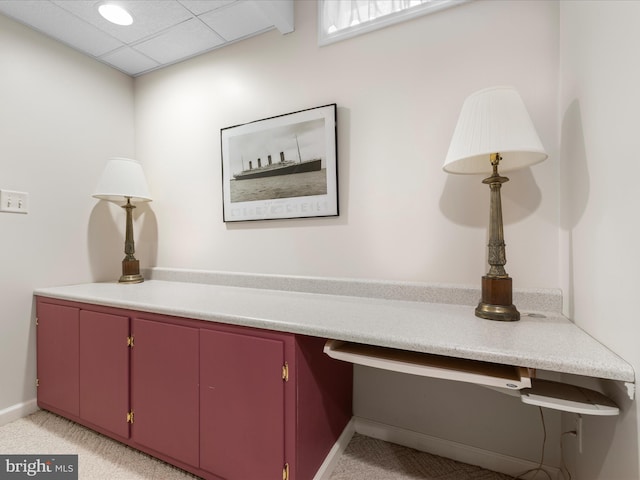 interior details with a paneled ceiling, baseboards, and carpet flooring