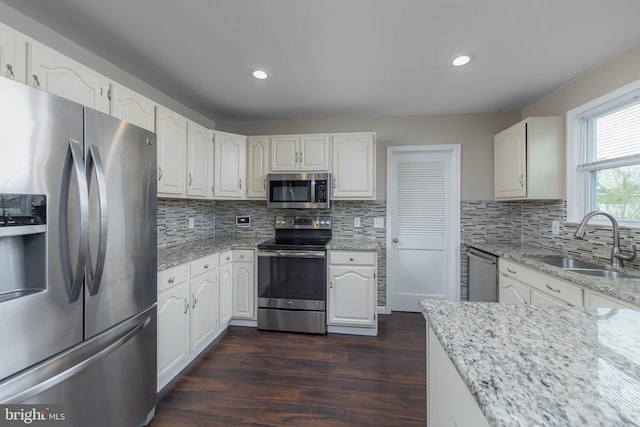 119 Field, Penns Grove, NJ 08069 - kitchen featuring white cabinets, a sink, dark wood-type flooring, light stone countertops, and appliances with stainless steel finishes