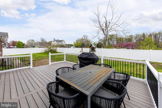 119 Field, Penns Grove, NJ 08069 - wooden terrace with a grill, a playground, a fenced backyard, outdoor dining area, and a lawn