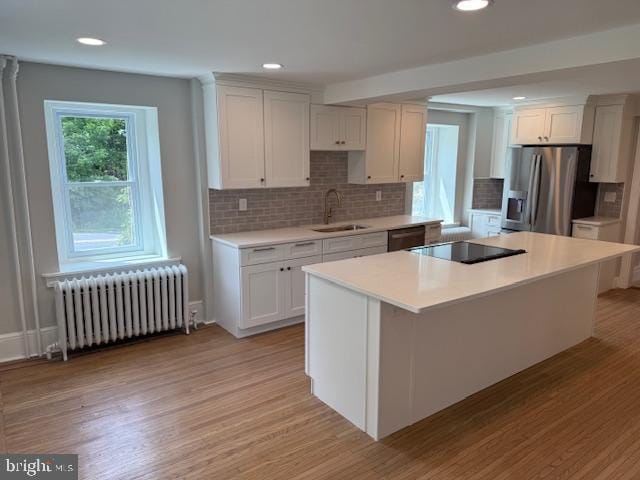 639 Old Airport Rd, Douglassville, PA 19518 - kitchen featuring radiator heating unit, stainless steel fridge, a sink, light wood finished floors, and recessed lighting