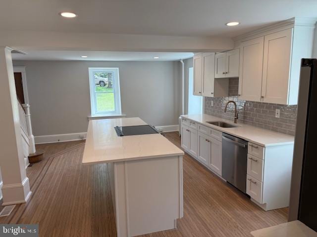 639 Old Airport Rd, Douglassville, PA 19518 - kitchen featuring a sink, black appliances, light countertops, light wood-type flooring, and a kitchen island