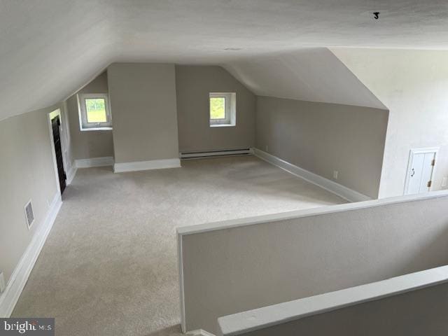 639 Old Airport Rd, Douglassville, PA 19518 - bonus room with a baseboard heating unit, vaulted ceiling, carpet flooring, plenty of natural light, and baseboards
