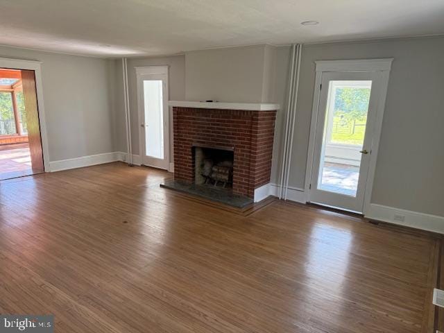 639 Old Airport Rd, Douglassville, PA 19518 - unfurnished living room featuring wood finished floors, a fireplace, and baseboards