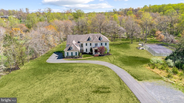 birds eye view of property featuring a view of trees
