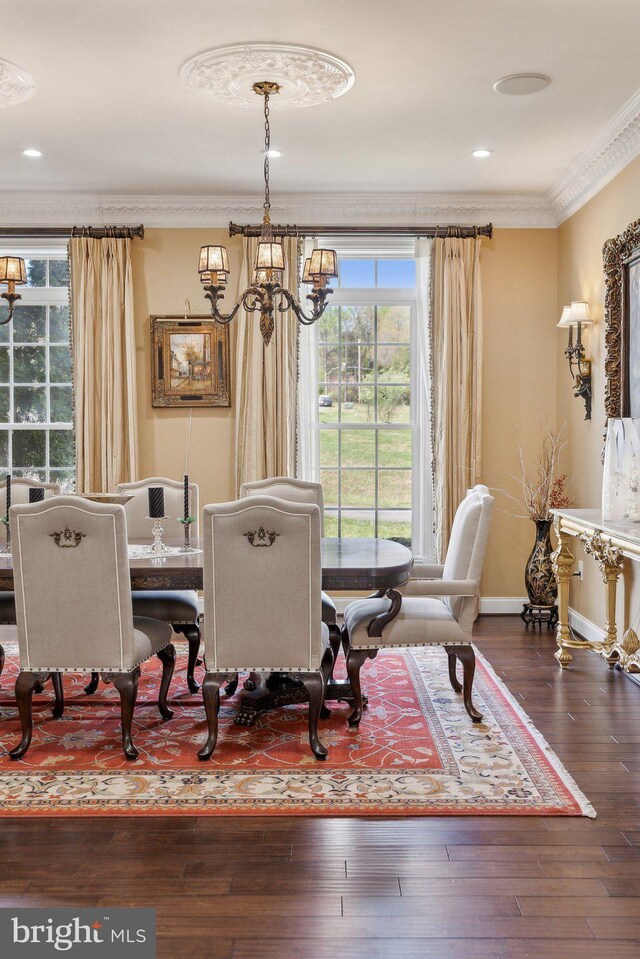 dining space featuring crown molding, a chandelier, and a wealth of natural light