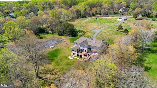 birds eye view of property with a view of trees