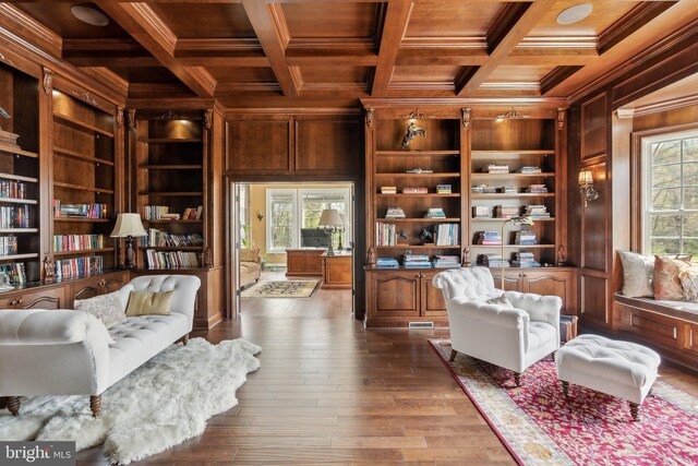 sitting room featuring wood walls, built in features, ornamental molding, wood ceiling, and coffered ceiling