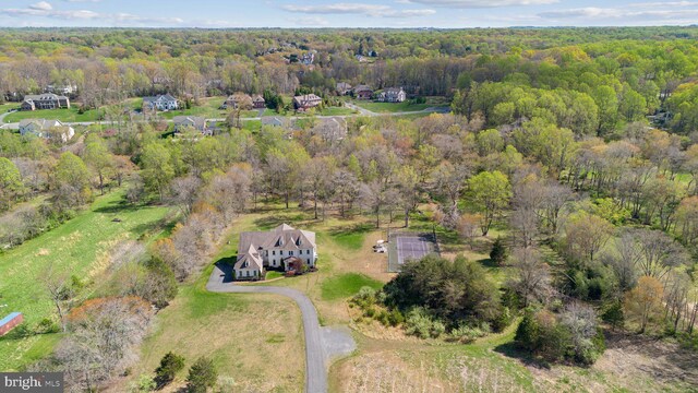 drone / aerial view featuring a wooded view