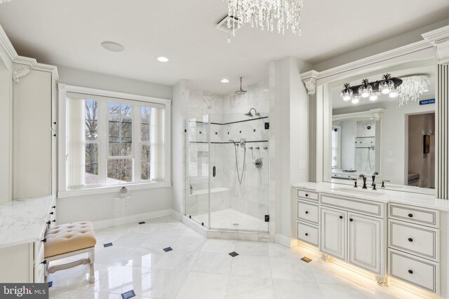 full bathroom featuring an inviting chandelier, vanity, recessed lighting, baseboards, and a stall shower