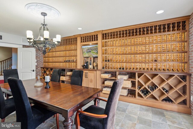 dining room with an inviting chandelier and stone finish floor