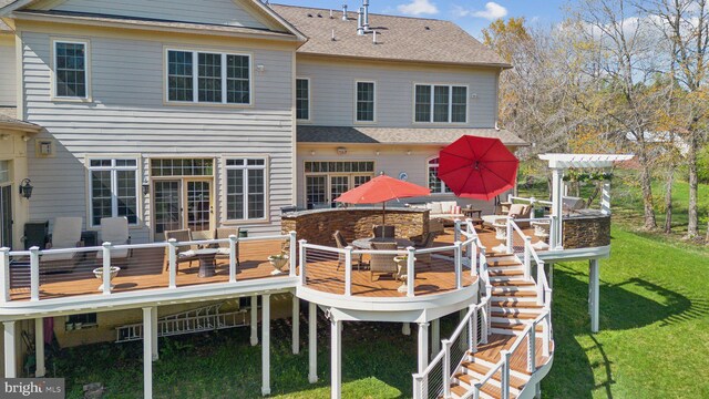 rear view of property with a yard, a deck, a shingled roof, and outdoor dining area