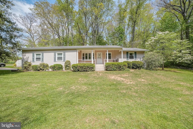 ranch-style house with a porch and a front lawn
