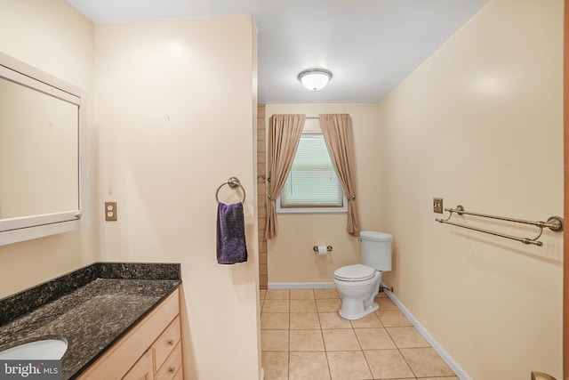 bathroom with vanity, baseboards, toilet, and tile patterned floors