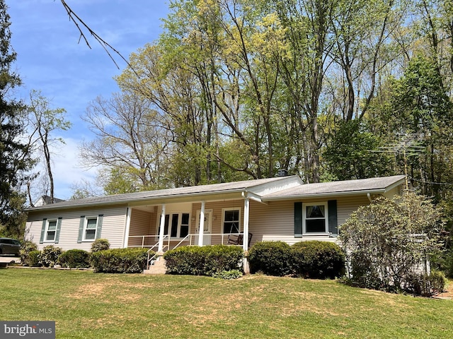 ranch-style home with covered porch and a front yard