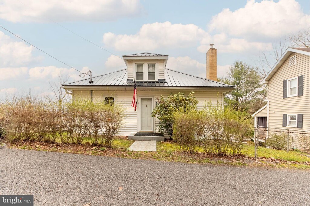 173 Halfmoon St, Philipsburg, PA 16866 - bungalow-style home with a chimney, fence, and metal roof