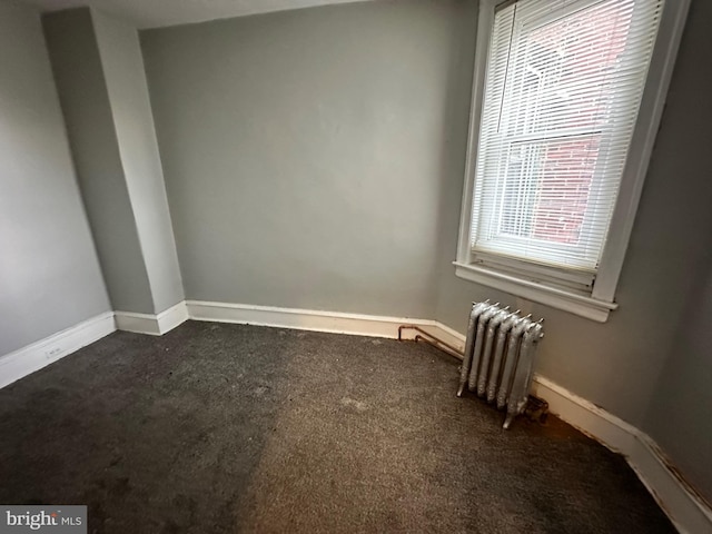 5934 Delancey St, Philadelphia, PA 19143 - spare room featuring radiator heating unit, baseboards, and dark carpet