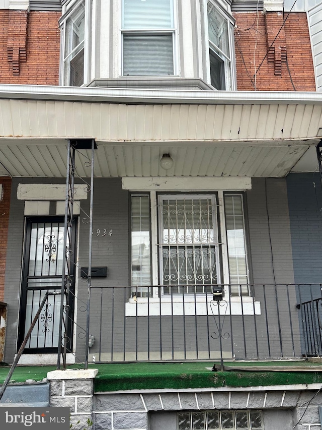 5934 Delancey St, Philadelphia, PA 19143 - doorway to property featuring brick siding and a porch
