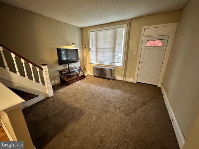 5934 Delancey St, Philadelphia, PA 19143 - carpeted foyer entrance featuring radiator, baseboards, and stairs