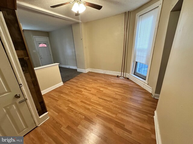 5934 Delancey St, Philadelphia, PA 19143 - empty room with a textured ceiling, wood finished floors, ceiling fan, and baseboards