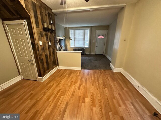 5934 Delancey St, Philadelphia, PA 19143 - interior space featuring radiator, ceiling fan, a textured ceiling, wood finished floors, and baseboards