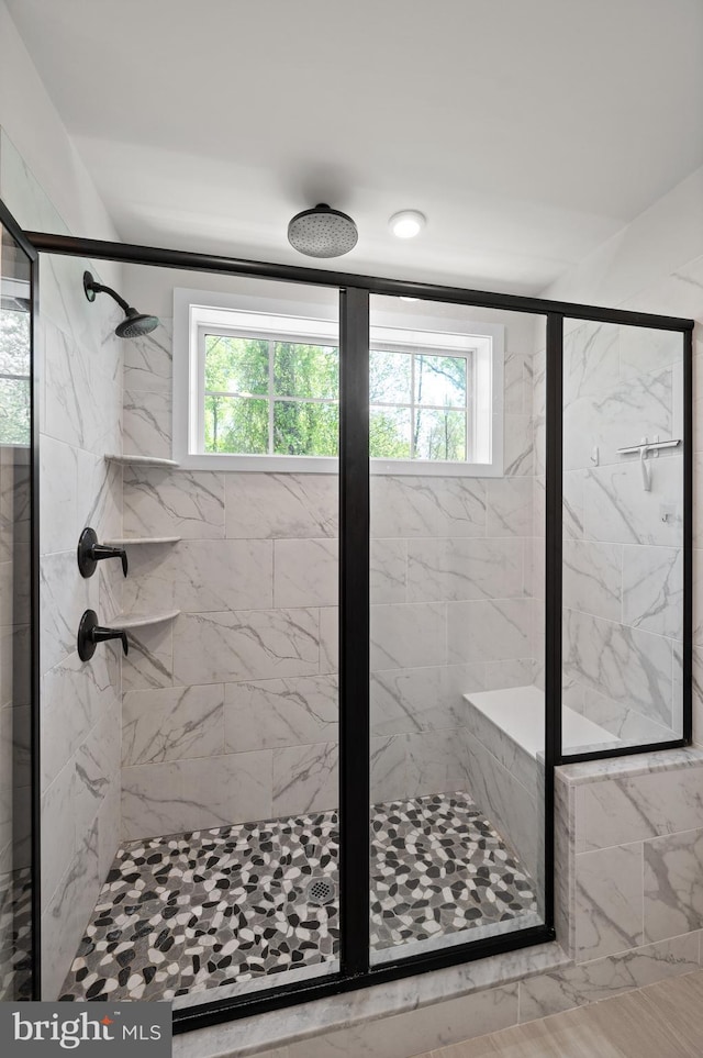 full bath with plenty of natural light and a stall shower