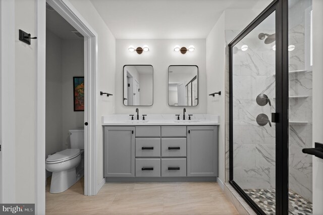full bath with a shower stall, toilet, double vanity, and a sink