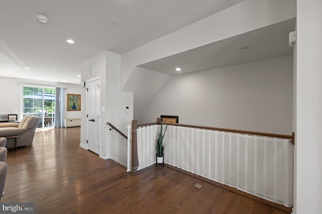 hallway featuring hardwood / wood-style floors, an upstairs landing, recessed lighting, and visible vents