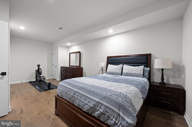 bedroom featuring wood-type flooring, baseboards, visible vents, and recessed lighting