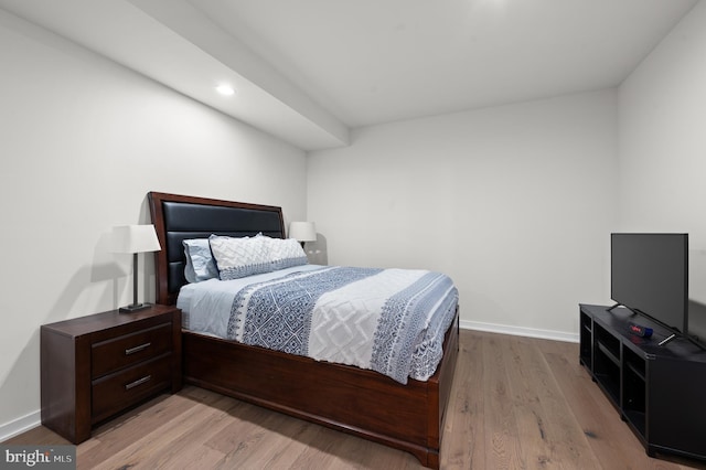 bedroom with baseboards, recessed lighting, and wood finished floors