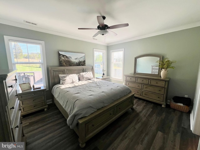 bedroom featuring dark wood-type flooring, visible vents, ornamental molding, and ceiling fan