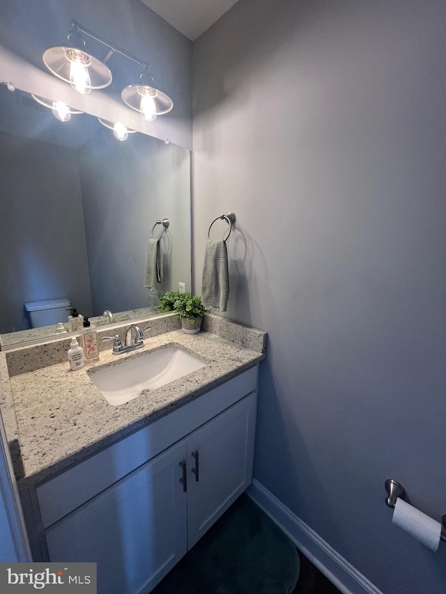 bathroom featuring vanity and baseboards