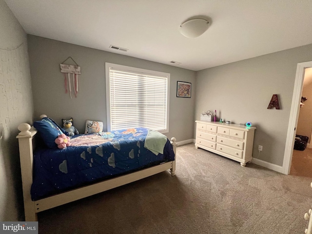 carpeted bedroom with visible vents and baseboards