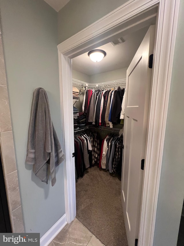 spacious closet with carpet flooring and visible vents