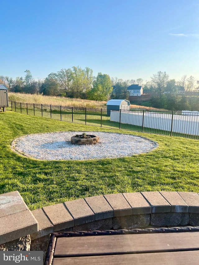 view of yard featuring fence and a fire pit