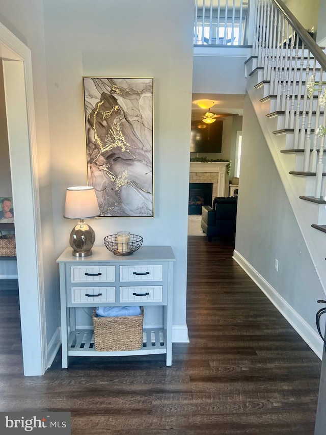 hall with baseboards, stairway, and dark wood-style floors