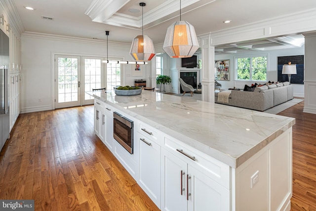 528 Prospect Ave, Princeton, NJ 08540 - kitchen with crown molding, open floor plan, stainless steel microwave, and decorative columns