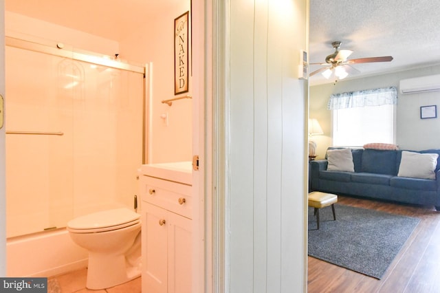 full bath with wood finished floors, toilet, ceiling fan, walk in shower, and an AC wall unit