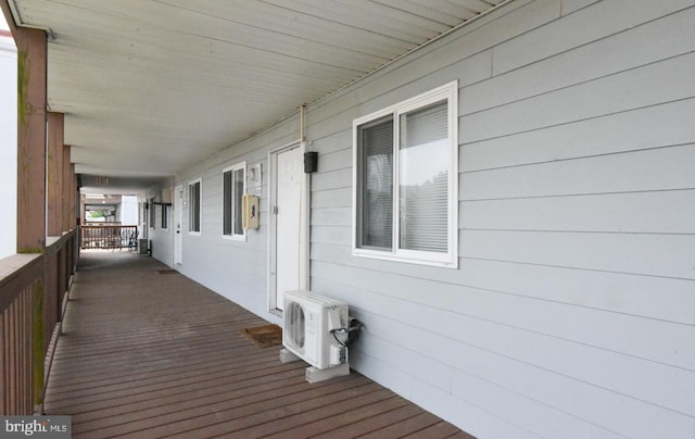 deck with covered porch and ac unit