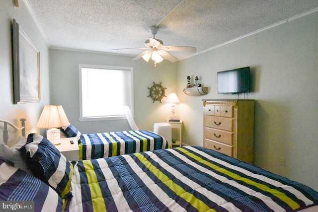 bedroom with a textured ceiling and ceiling fan