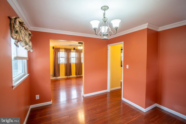 spare room featuring wood finished floors, baseboards, and ornamental molding