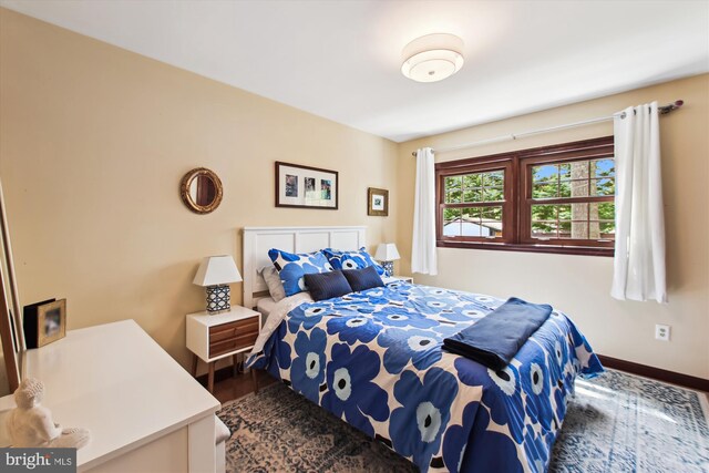 bedroom featuring wood finished floors and baseboards