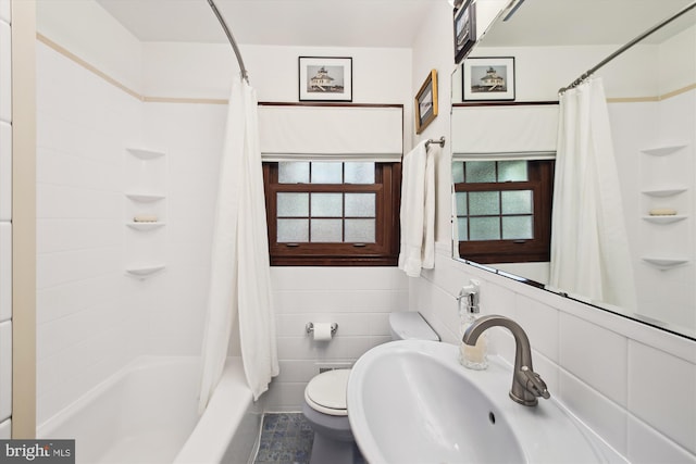 full bath featuring shower / bath combo with shower curtain, toilet, and a sink
