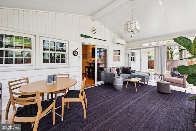 sunroom with beamed ceiling, a notable chandelier, and a wall unit AC