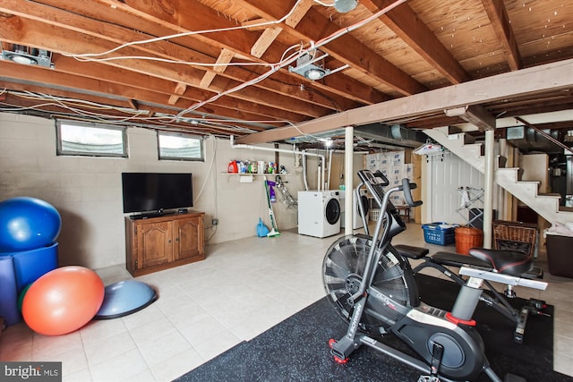 workout area with independent washer and dryer and concrete block wall