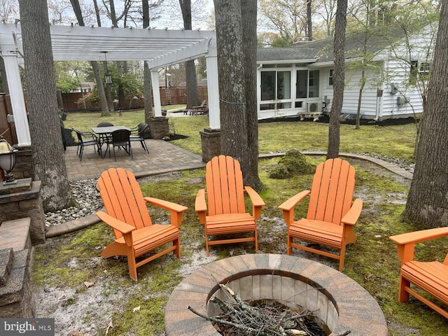view of patio / terrace with fence, a pergola, a fire pit, and a sunroom