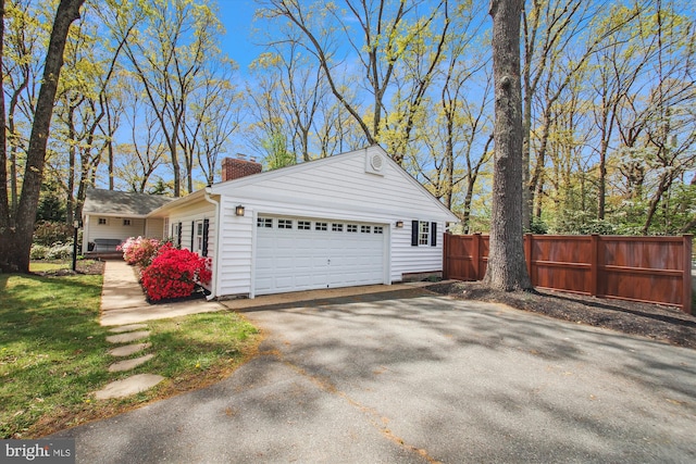 detached garage featuring fence